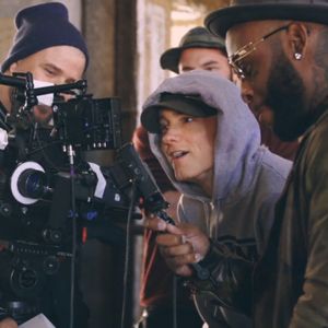 Eminem posing a smile in front of the camera on a video shoot