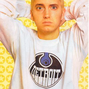 Eminem posing with a yellow background