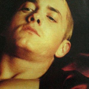 Eminem lying in the bed with red clothes