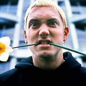 Eminem with a white flower in his mouth
