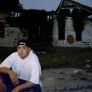 Young Eminem Posing in front of burned house
